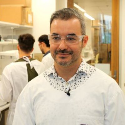 A man in a lab coat and glasses